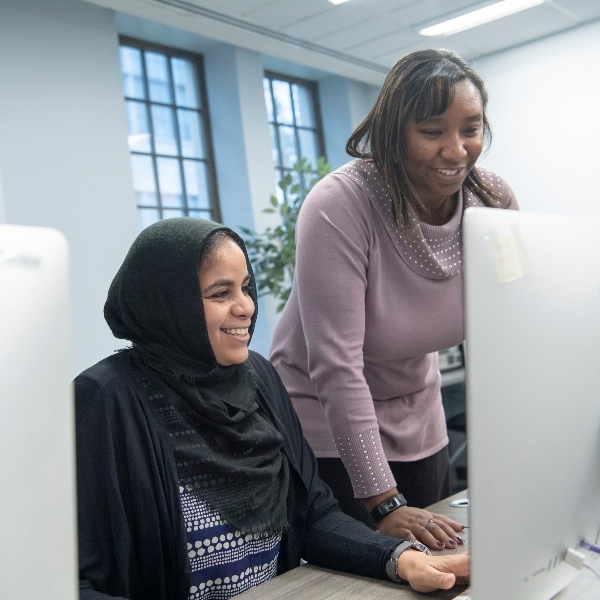two female students working together at a computer