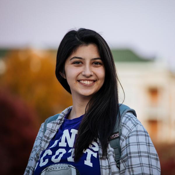 Smiling student with dark hair looks directly at camera.